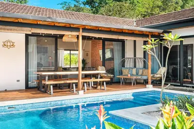 a patio with a picnic table and a pool at CU21 Stylish 5BR Home with Pool and Casita Close to Beach in Tamarindo