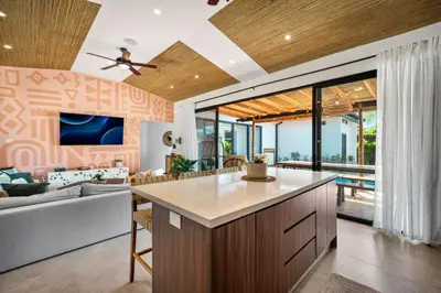 an open kitchen and living room with a couch at CU21 Stylish 5BR Home with Pool and Casita Close to Beach in Tamarindo