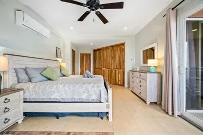 a bedroom with a bed and a ceiling fan at Ocean View Condo in Tamarindo Steps to the Sand in Tamarindo