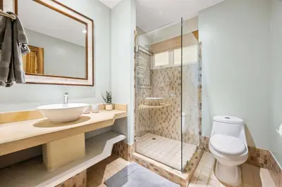 a bathroom with a toilet and a sink and a shower at Ocean View Condo in Tamarindo Steps to the Sand in Tamarindo
