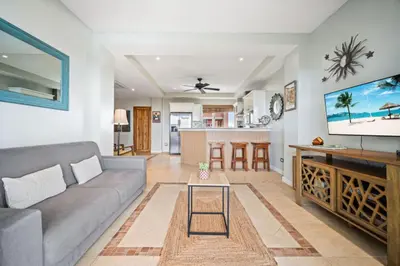a living room with a couch and a tv at Ocean View Condo in Tamarindo Steps to the Sand in Tamarindo
