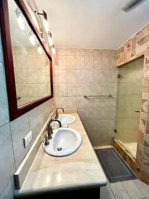 a bathroom with two sinks and a shower at Stunning Ocean-View 2 BD Overlooking Tamarindo in Tamarindo
