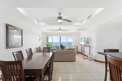 a dining room and living room with a table and a couch at Stunning Ocean-View 2 BD Overlooking Tamarindo in Tamarindo