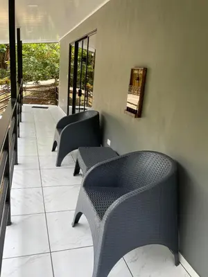 a row of chairs sitting next to a wall at La Casita in San Isidro