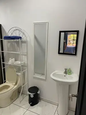 a bathroom with a toilet and a sink and a mirror at La Casita in San Isidro