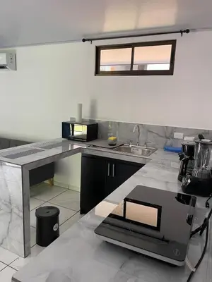 a kitchen with a sink and a counter top at La Casita in San Isidro