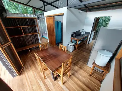 a room with a table and chairs and a desk at Jungle Studio in Drake Bay in Drake