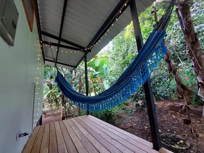 a hammock on a porch of a house at Jungle Studio in Drake Bay in Drake