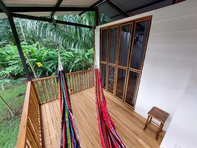 a porch of a house with hammocks on it at Jungle Studio in Drake Bay in Drake
