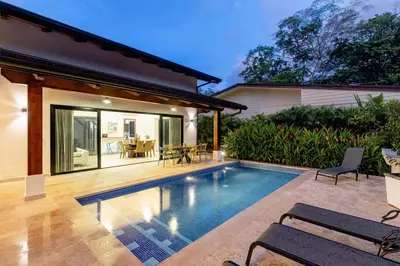a swimming pool in the backyard of a house at Private Pool Luxury Modern House - Llama del Bosque - Reserva Conchal Golf Resort in Playa Conchal