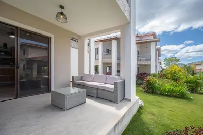 a patio of a house with a couch and a yard at Casa Mango - Villaggio 6 in Potrero