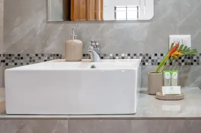 a white bathroom sink with a soap dispenser on it at Casa Mango - Villaggio 6 in Potrero
