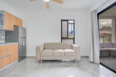 a living room with a chair and a couch at Casa Mango - Villaggio 6 in Potrero
