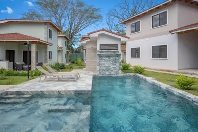 a swimming pool in front of a house at Casa Mango - Villaggio 6 in Potrero