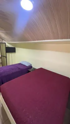two beds in a room with purple blankets at Casa Antioquia #4 in Garita