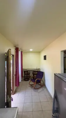 a living room with a blue chair and a table at Casa Antioquia #4 in Garita