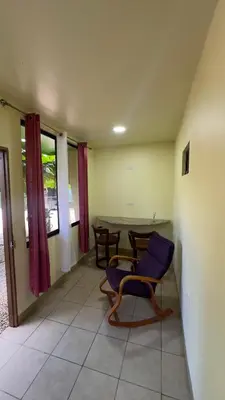 a living room with a blue chair and a table at Casa Antioquia #4 in Garita