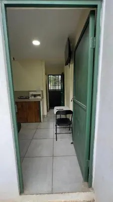 an empty hallway with a table and a green door at Casa Antioquia #2 in Garita