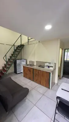 a living room with a staircase and a desk at Casa Antioquia #2 in Garita