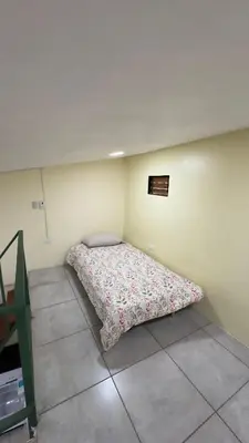 a bedroom with a bed in the corner of a room at Casa Antioquia #2 in Garita
