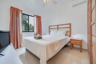 a bedroom with a large bed and a window at Casa Luna - Villaggio 6 in Potrero