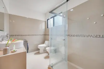 a bathroom with a glass shower and a toilet at Casa Luna - Villaggio 6 in Potrero