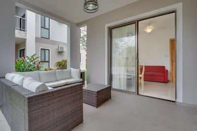 a living room with a couch and a red chair at Casa Luna - Villaggio 6 in Potrero