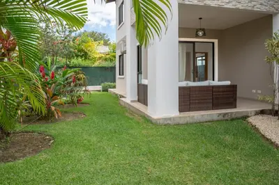 a house with a yard with green grass at Casa Luna - Villaggio 6 in Potrero