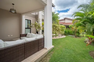 an outdoor patio with white furniture and a lawn at Casa Luna - Villaggio 6 in Potrero