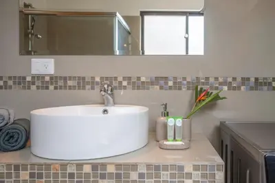 a bathroom with a white sink and a mirror at Casa Luna - Villaggio 6 in Potrero