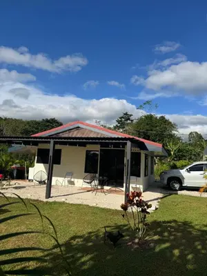 a house with a car parked in front of it at Nature and Views - 30 min to La Fortuna in Tigra