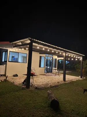 a house with lights on it at night at Nature and Views - 30 min to La Fortuna in Tigra