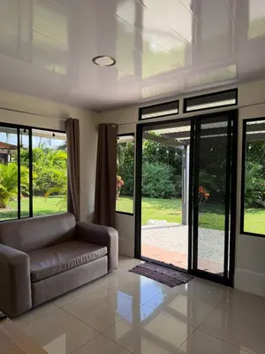 a living room with a couch and sliding glass doors at Nature and Views - 30 min to La Fortuna in Tigra