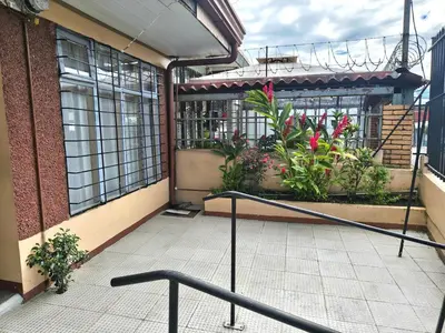 a balcony of a building with plants and windows at Casa Brasil in Alajuela City