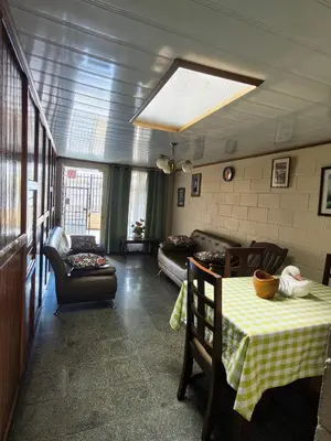 a living room with a table and a couch at Casa Brasil in Alajuela City
