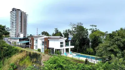 a house with a swimming pool next to a building at Breathtaking Views from a Luxury New Villa at Mar a Mar in Jacó