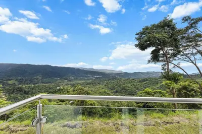 a view of the mountains from the balcony of a house at Breathtaking Views from a Luxury New Villa at Mar a Mar in Jacó