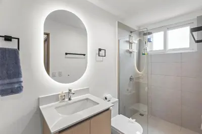 a white bathroom with a sink and a mirror at Breathtaking Views from a Luxury New Villa at Mar a Mar in Jacó