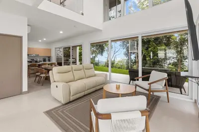 a living room with a couch and a table at Breathtaking Views from a Luxury New Villa at Mar a Mar in Jacó