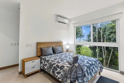 a bedroom with a bed and a large window at Breathtaking Views from a Luxury New Villa at Mar a Mar in Jacó