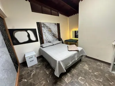 a bedroom with a bed and a tv in it at Hostal Canarias in San José