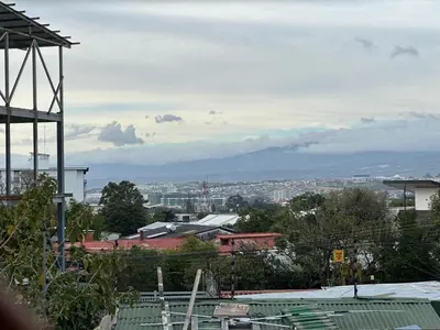 a view of a city with mountains in the background at Hostal Canarias in San José