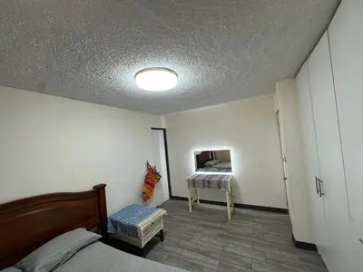 a bedroom with a bed and a room with a table at Hostal Canarias in San José