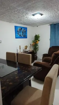 a living room with a table and some chairs at Cerca estadio Nacional in San José