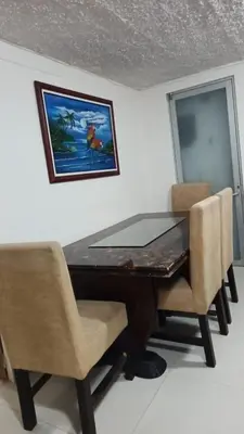 a dining room table with chairs and a picture on the wall at Cerca estadio Nacional in San José