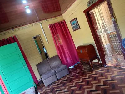 a living room with a couch and a chair at The Johnson's Village in Madre de Dios
