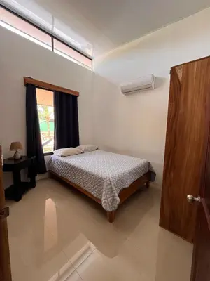 a bedroom with a bed and a window at Accommodation in Tamarindo in Garita