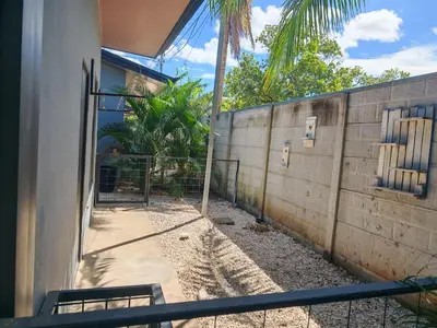 an outside view of a building with a fence at Accommodation in Tamarindo in Garita