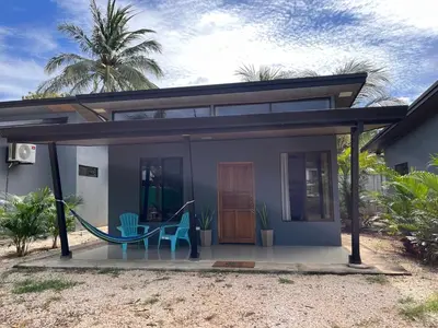 a house with a hammock in front of it at Accommodation in Tamarindo in Garita