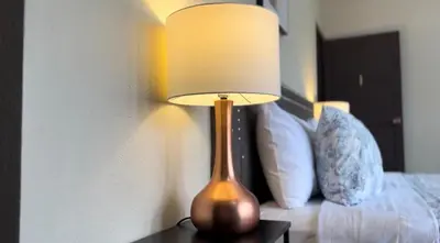 a lamp sitting on a table next to a bed at Cata bed & breakfast 2026 in San José